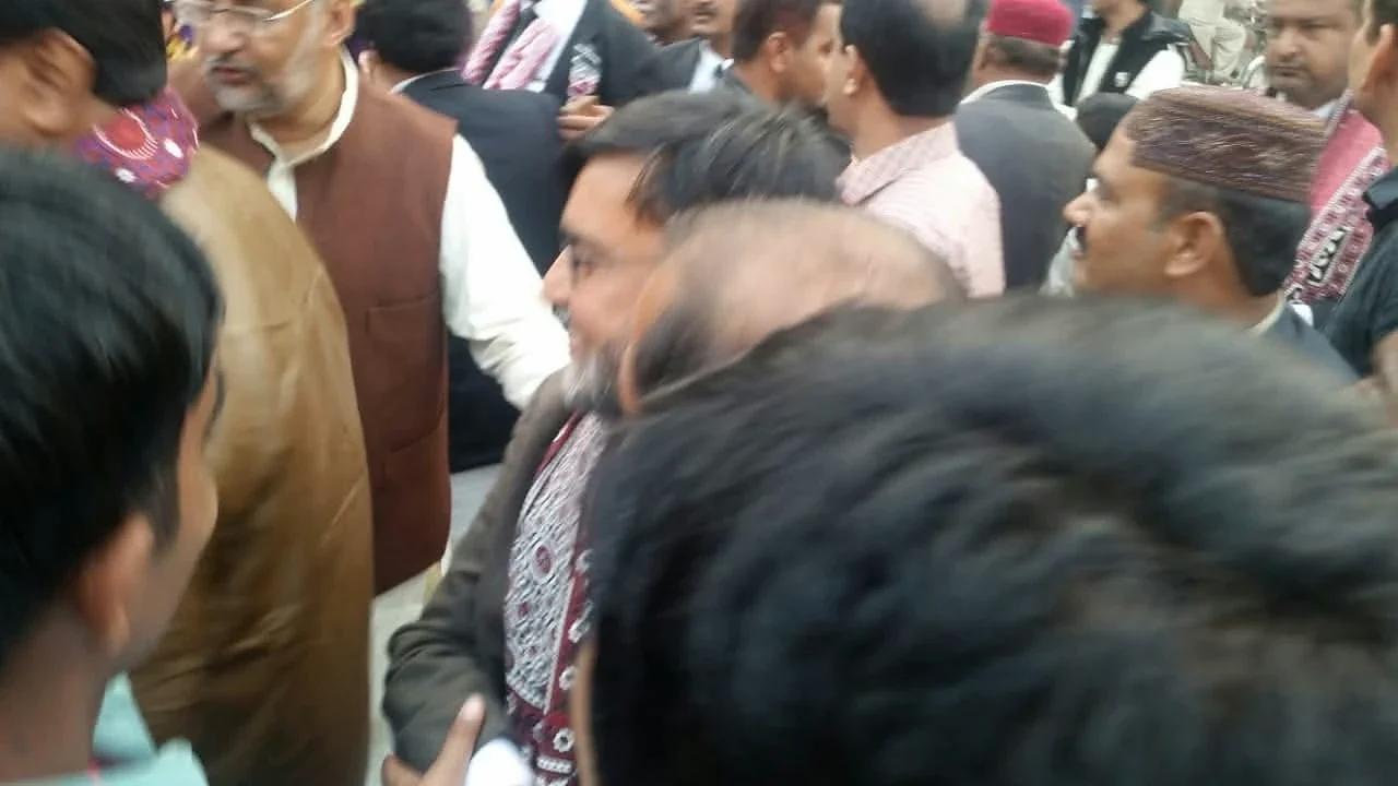 A close view of people standing together in a crowded outdoor setting.