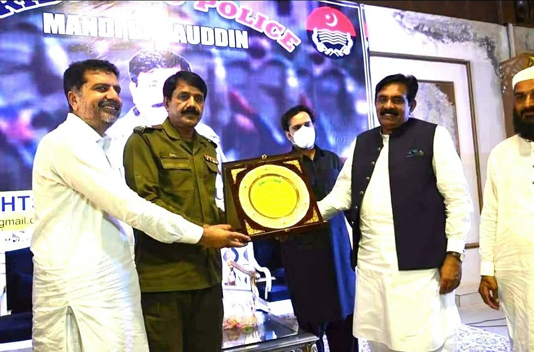 Men holding a framed presentation plaque in front of a large HRPF event backdrop.